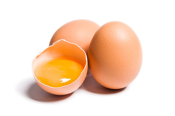 Two-and-a-half eggs. The half-egg is a bowl shape holding a bright yellow yolk.